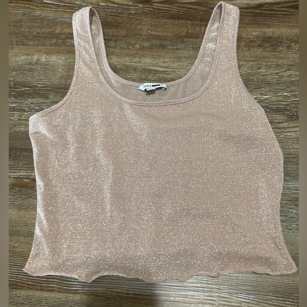 I’m selling a pinkish tank top, it’s glittery and thin a little see through